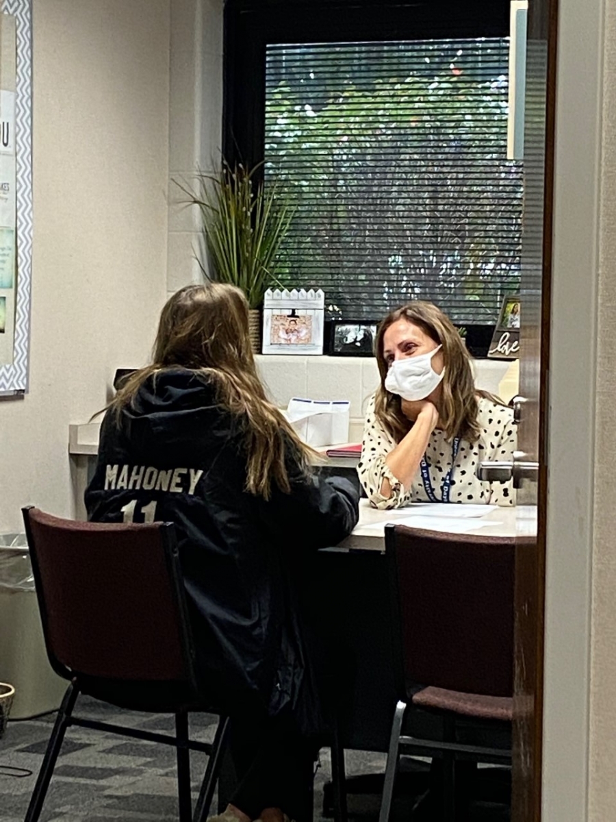 two females sitting at a desk